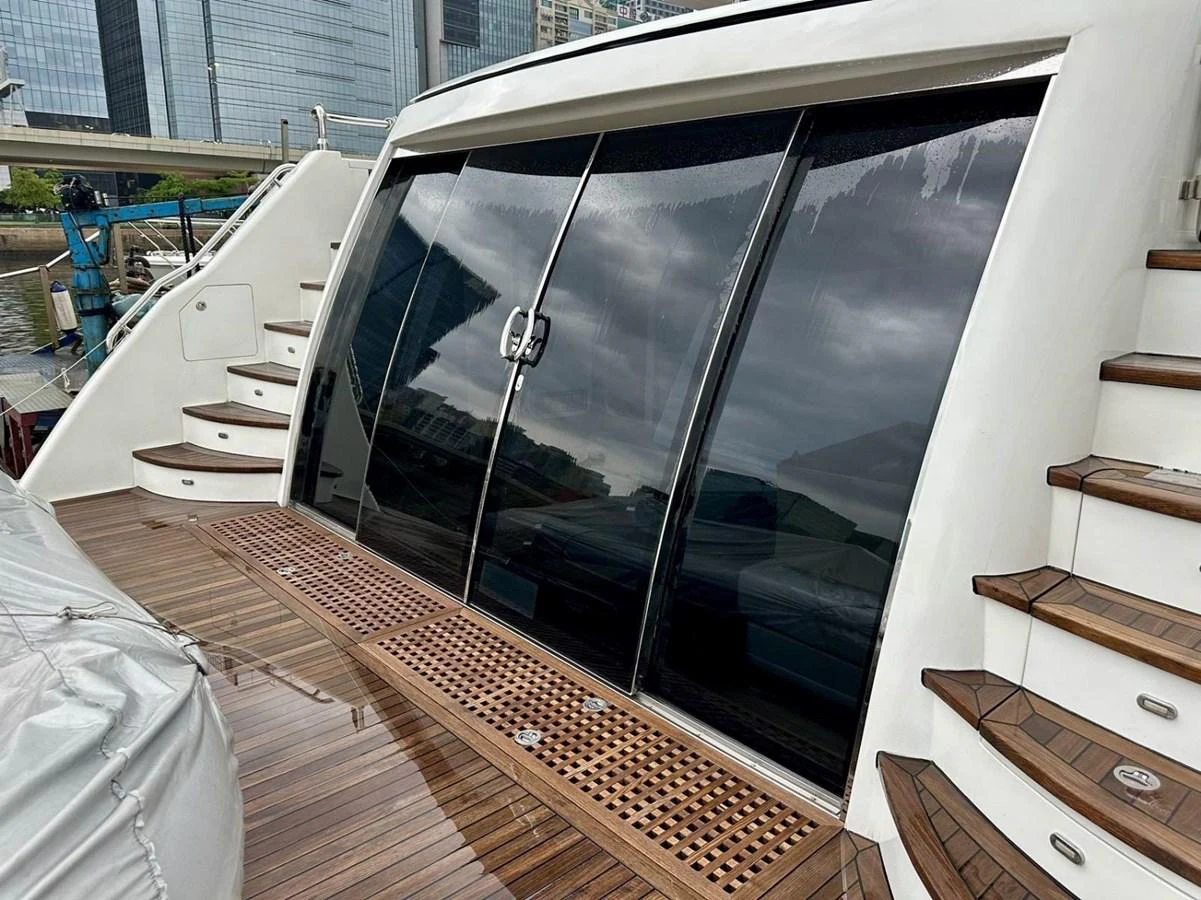 The yacht's aft deck features elegant wooden steps and sleek glass doors, providing a sophisticated entryway. aboard HEYSEA ASTERIA 126/1 Yacht for Sale