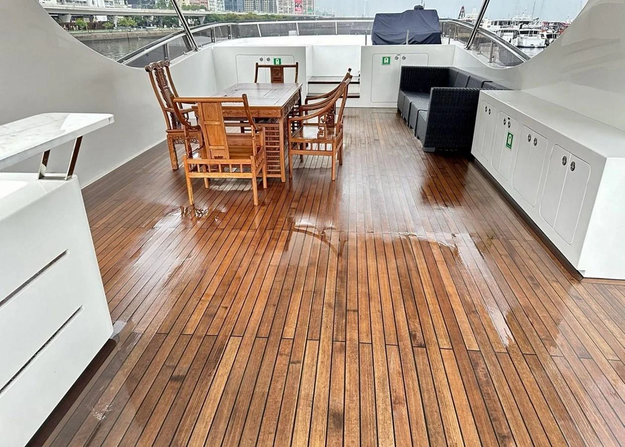 The aft deck features a spacious seating area with wooden flooring and a dining table, perfect for outdoor gatherings. aboard HEYSEA ASTERIA 126/1 Yacht for Sale