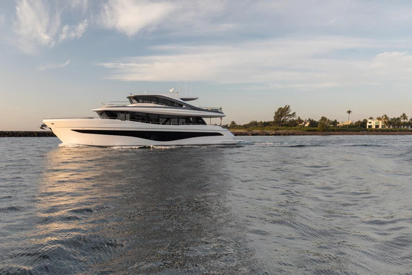 A sleek, modern yacht cruises gracefully on calm waters under a serene sky. aboard PRINCESS X80 Yacht for Sale