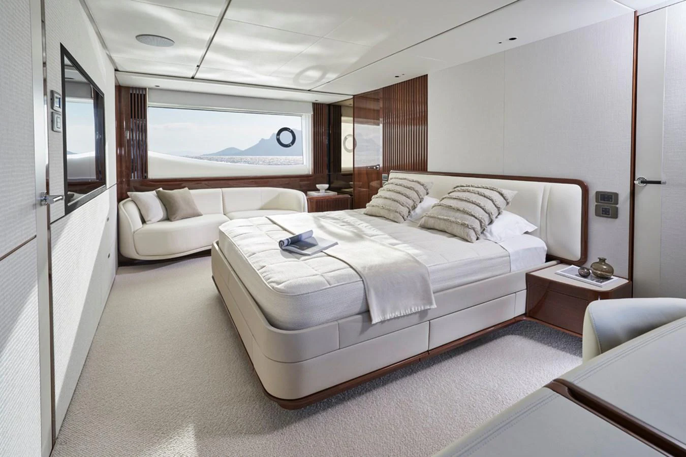 The master stateroom features a luxurious bed, elegant furnishings, and a large window with a scenic view. aboard PRINCESS X80 Yacht for Sale