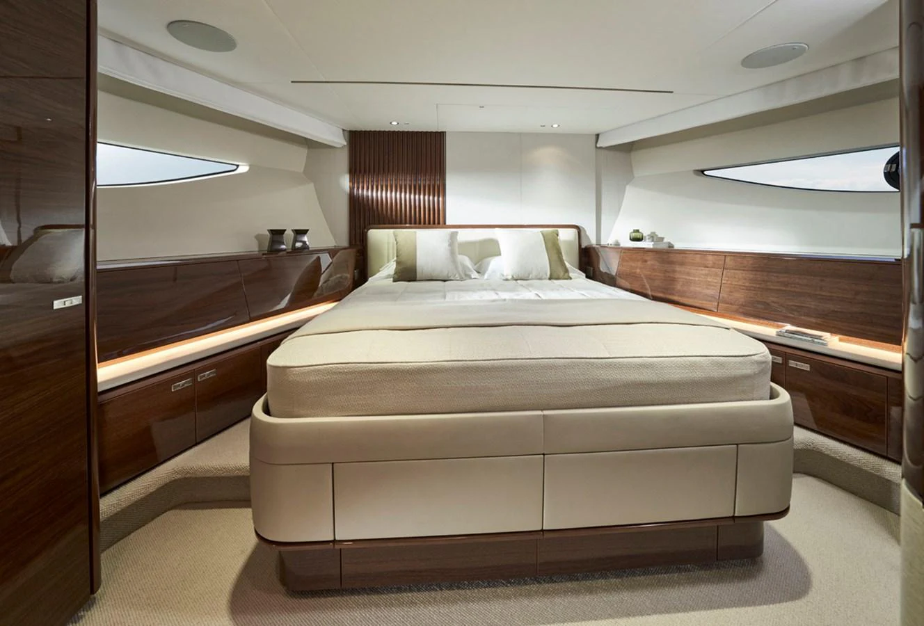 The master stateroom features a luxurious bed with elegant wood paneling and ample natural light. aboard PRINCESS X80 Yacht for Sale
