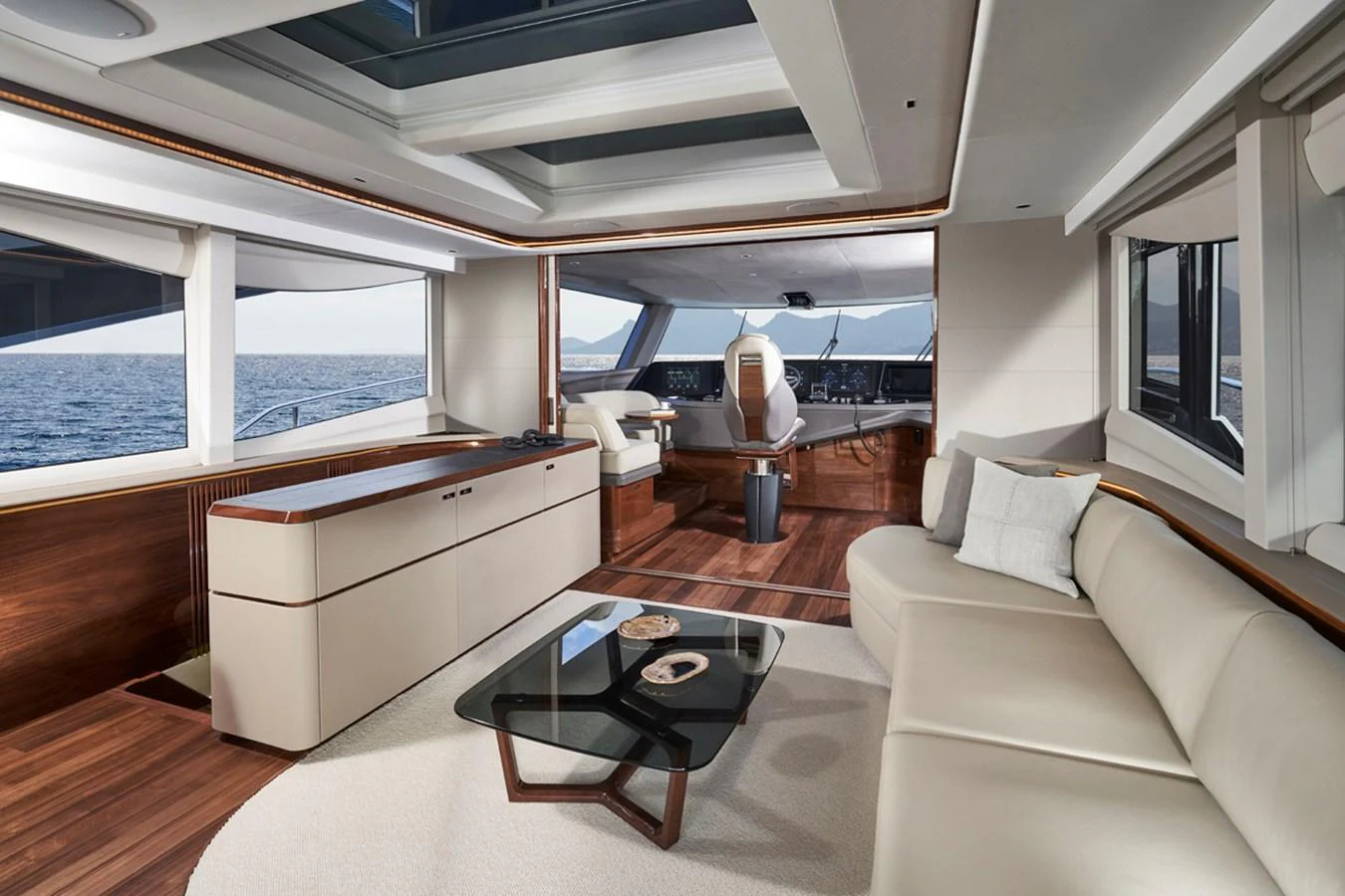 The salon features elegant furnishings with panoramic windows offering stunning sea views. aboard PRINCESS X80 Yacht for Sale