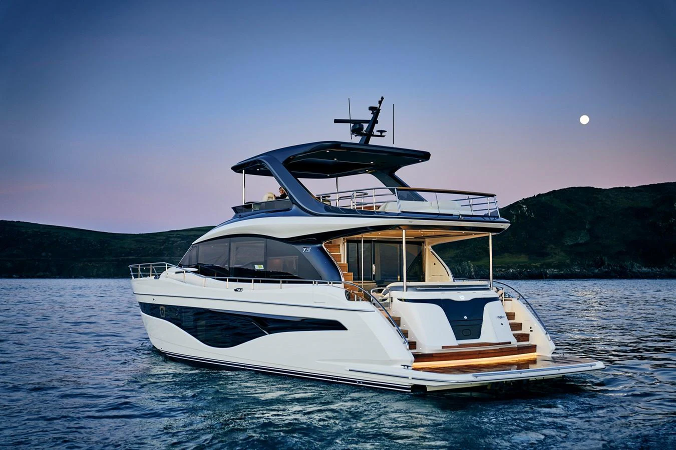 A sleek and modern yacht glides gracefully on calm waters at dusk. aboard PRINCESS Y72 Yacht for Sale