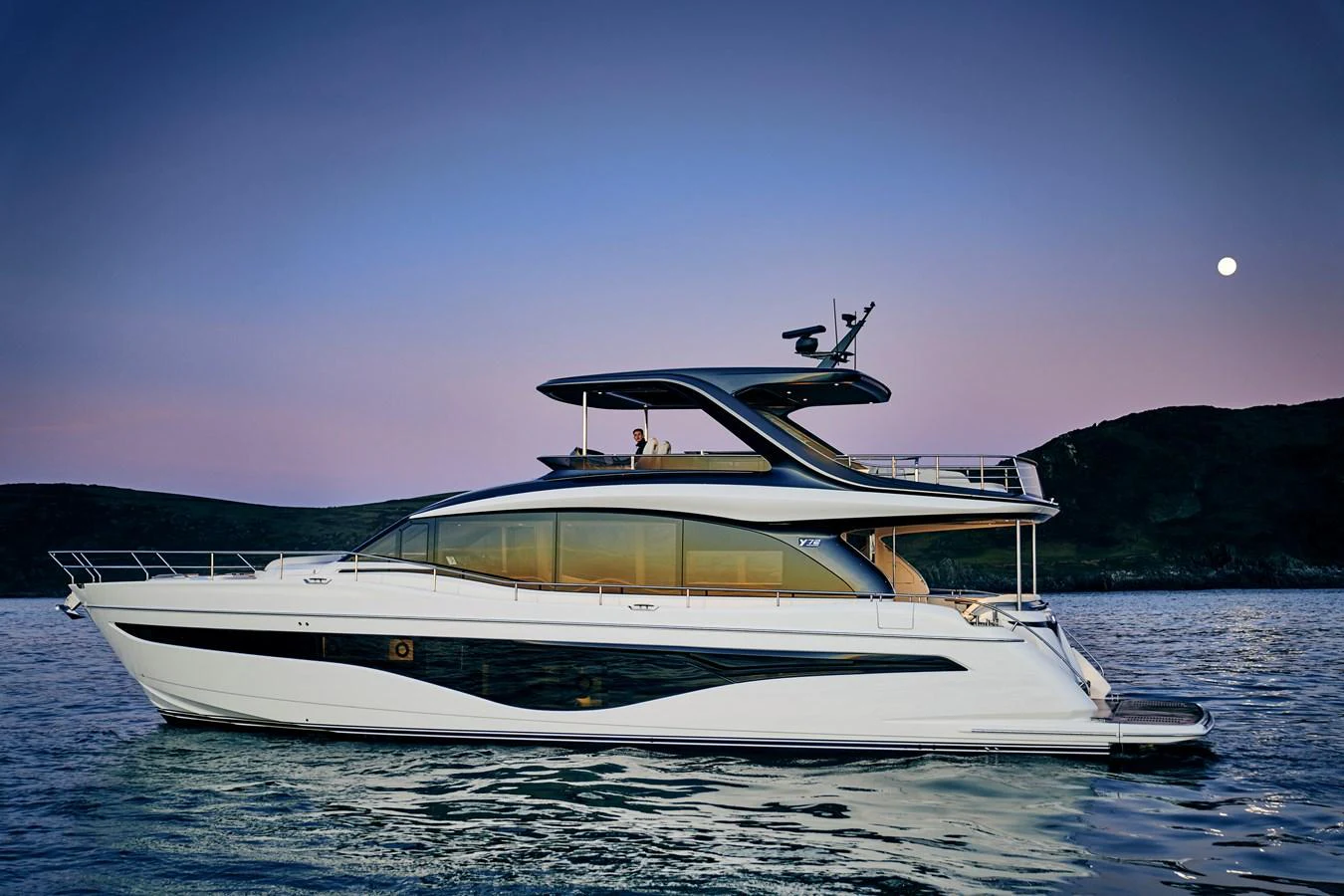 A sleek and modern yacht cruises gracefully on calm waters at dusk. aboard PRINCESS Y72 Yacht for Sale
