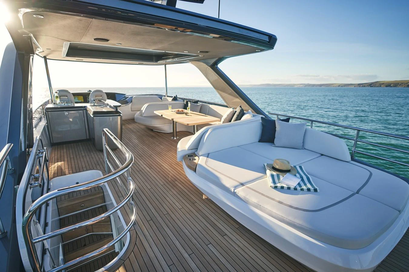The aft deck features a spacious lounging area with comfortable seating and a dining table, perfect for relaxing and entertaining. aboard PRINCESS Y72 Yacht for Sale