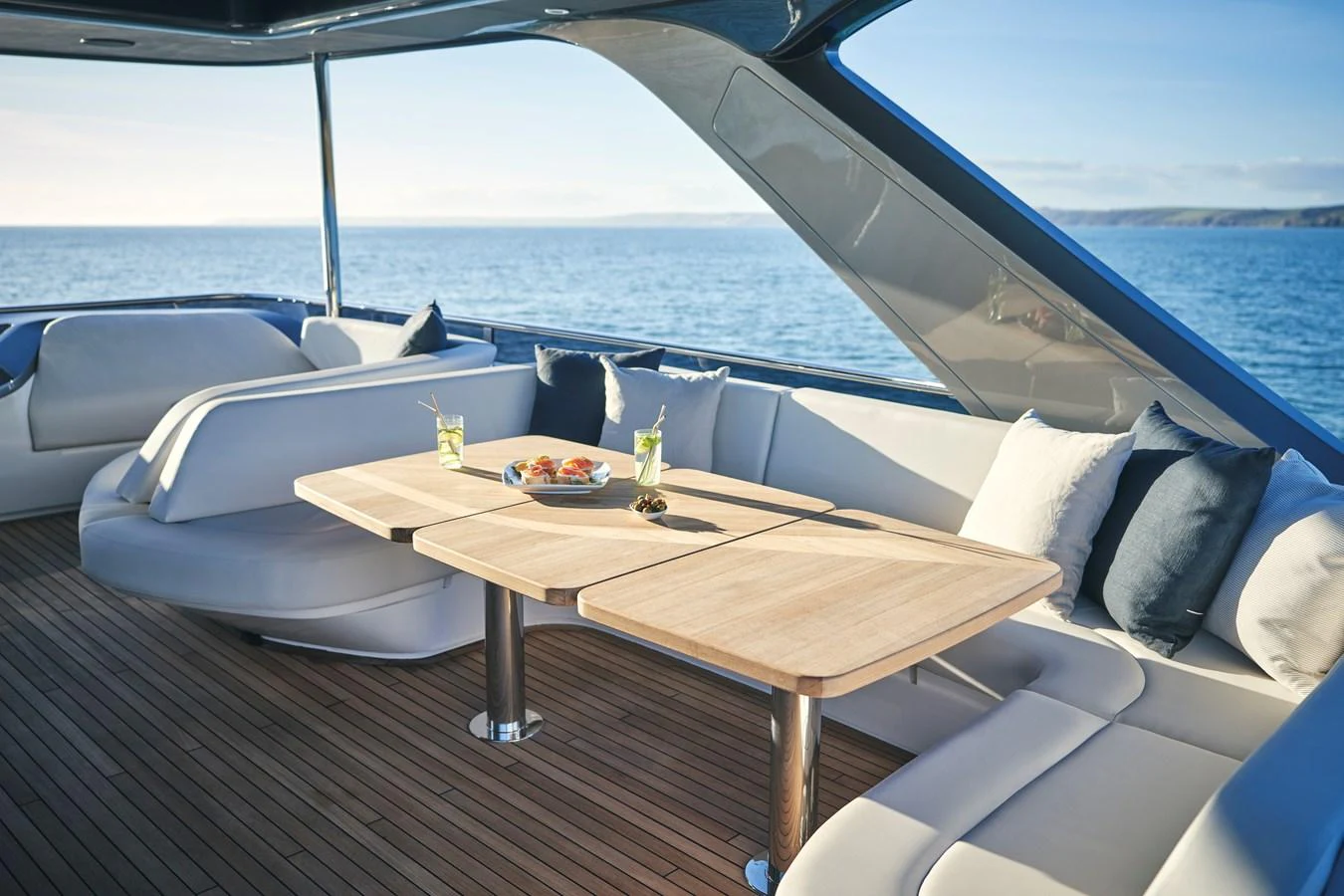 The aft deck features a stylish dining area with comfortable seating and a scenic ocean view. aboard PRINCESS Y72 Yacht for Sale