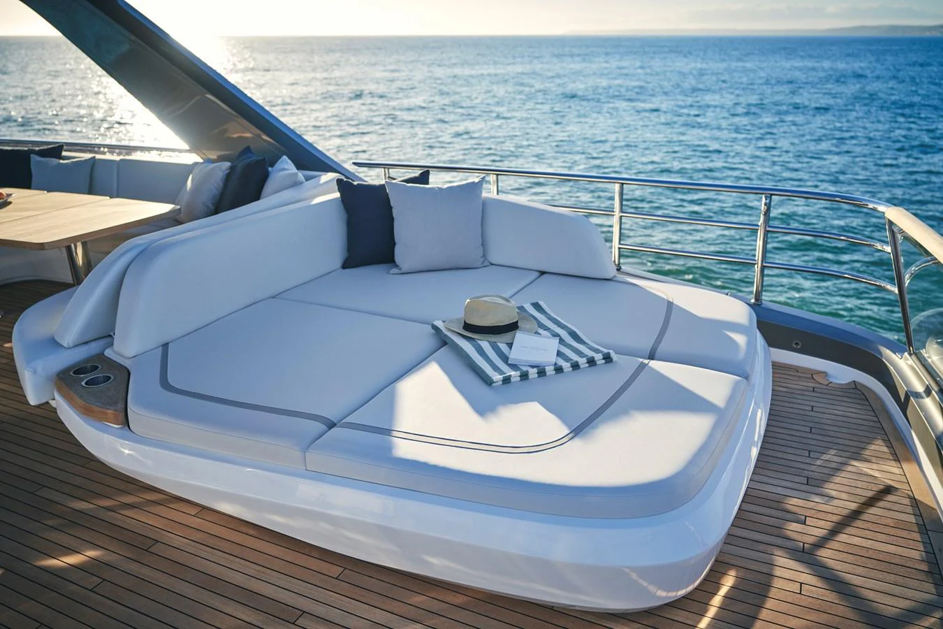 The sundeck features a luxurious sunbed with a stunning ocean view. aboard PRINCESS Y72 Yacht for Sale
