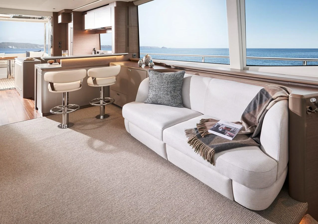 The salon offers a cozy and inviting space with panoramic ocean views. aboard PRINCESS Y72 Yacht for Sale