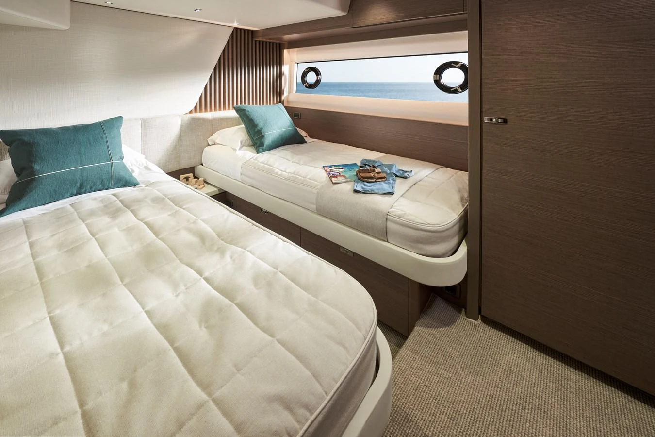 The guest stateroom features twin beds with elegant bedding and a view of the sea. aboard PRINCESS Y72 Yacht for Sale