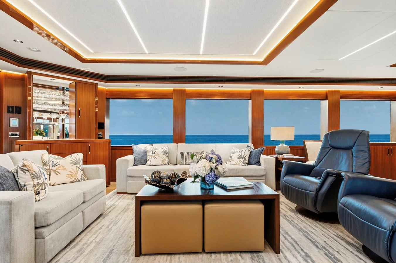 The salon offers a luxurious and comfortable space with ample seating and ocean views. aboard SEAS THE DAY Yacht for Sale