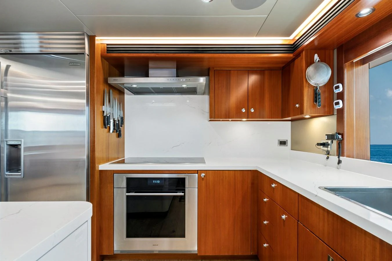 The yacht's galley features modern appliances and sleek wooden cabinetry, creating a functional and stylish cooking space. aboard SEAS THE DAY Yacht for Sale