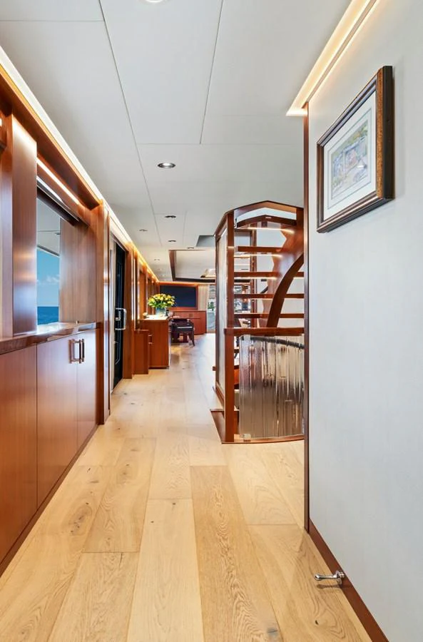 A sleek and modern hallway with wooden accents and elegant lighting. aboard SEAS THE DAY Yacht for Sale