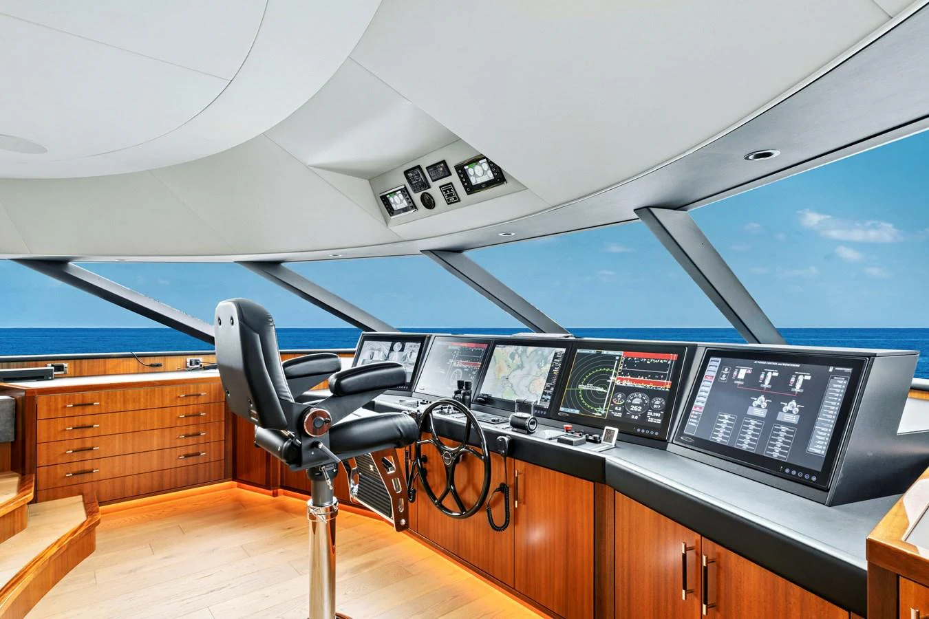 The helm features advanced navigation systems and a panoramic view of the ocean. aboard SEAS THE DAY Yacht for Sale