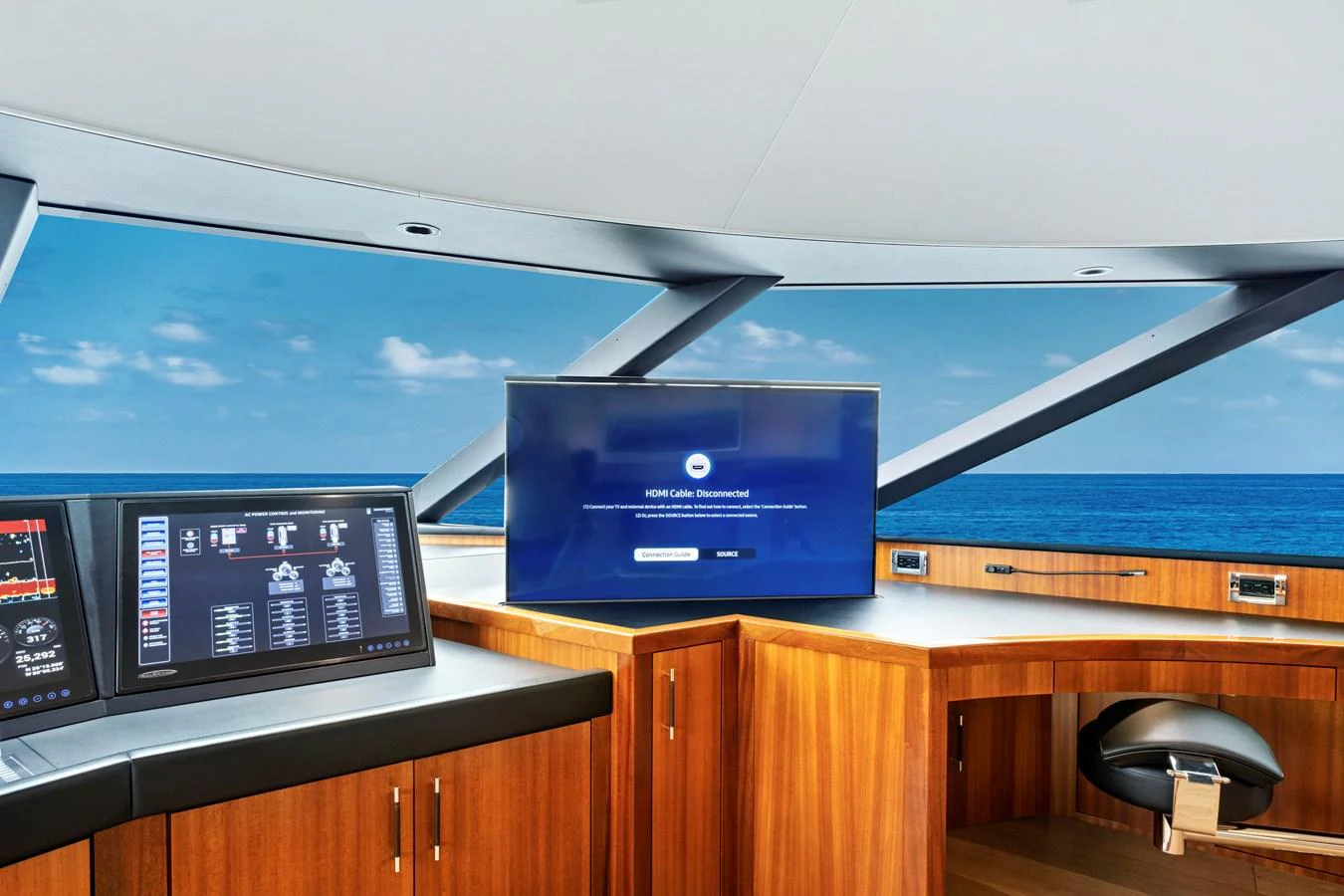 The helm features state-of-the-art navigation equipment and a stunning ocean view. aboard SEAS THE DAY Yacht for Sale