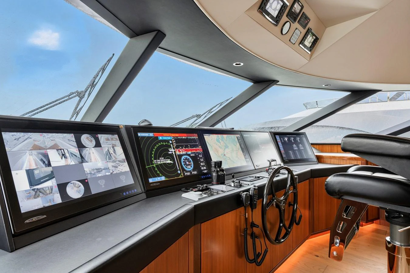 The helm station features advanced navigation systems and luxurious seating, offering a commanding view through expansive windows. aboard SEAS THE DAY Yacht for Sale