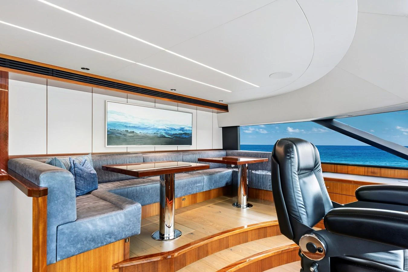 The salon features a spacious seating area with panoramic ocean views. aboard SEAS THE DAY Yacht for Sale