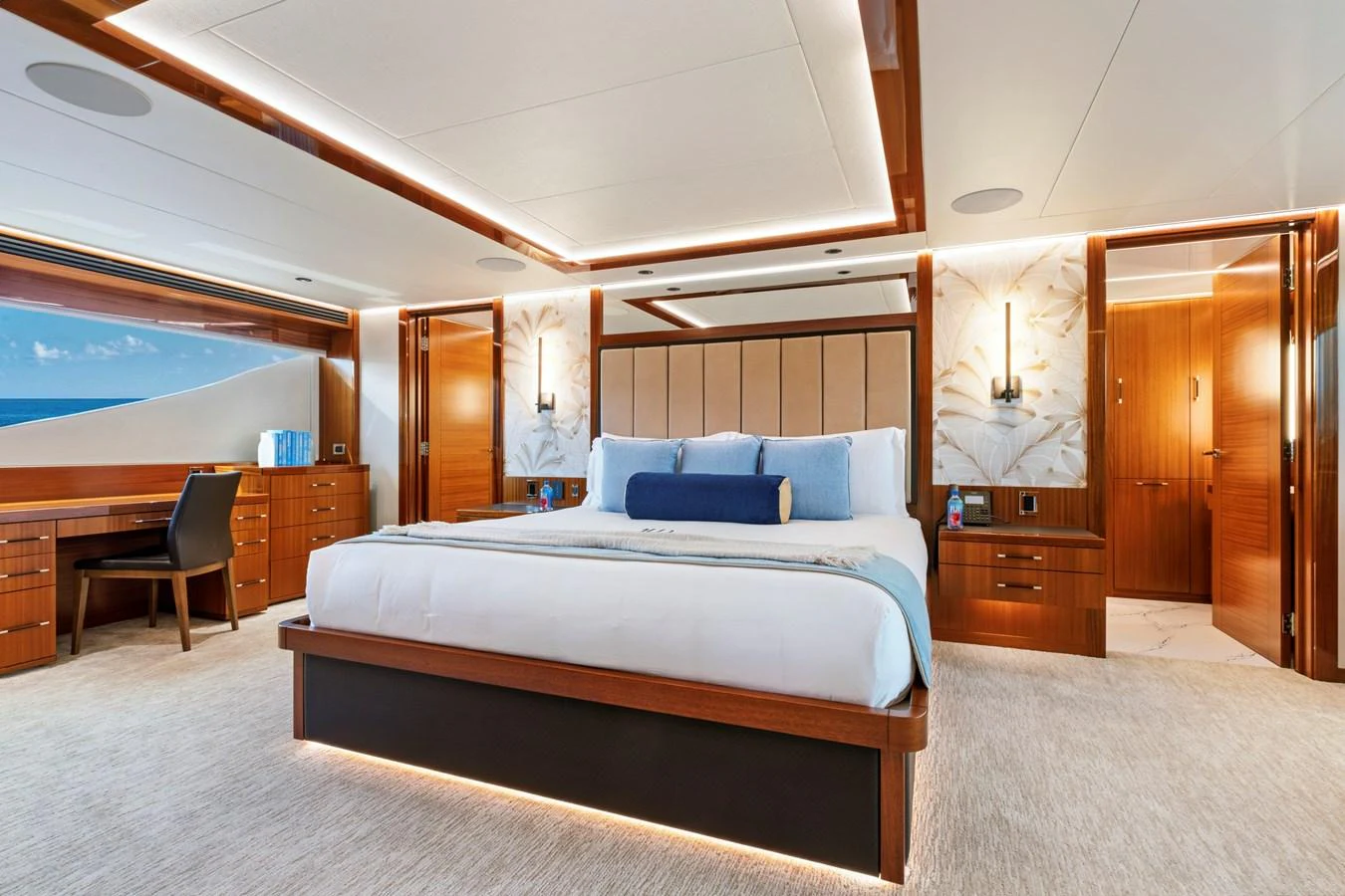 The master stateroom features a luxurious bed, elegant wood finishes, and ample natural light. aboard SEAS THE DAY Yacht for Sale