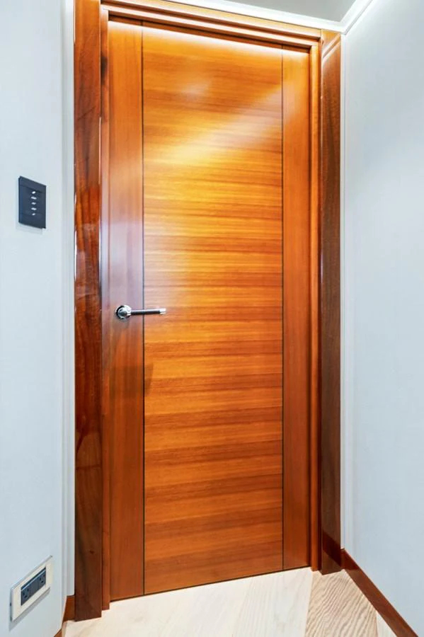 A sleek wooden door with a modern handle adds elegance to the yacht's interior. aboard SEAS THE DAY Yacht for Sale