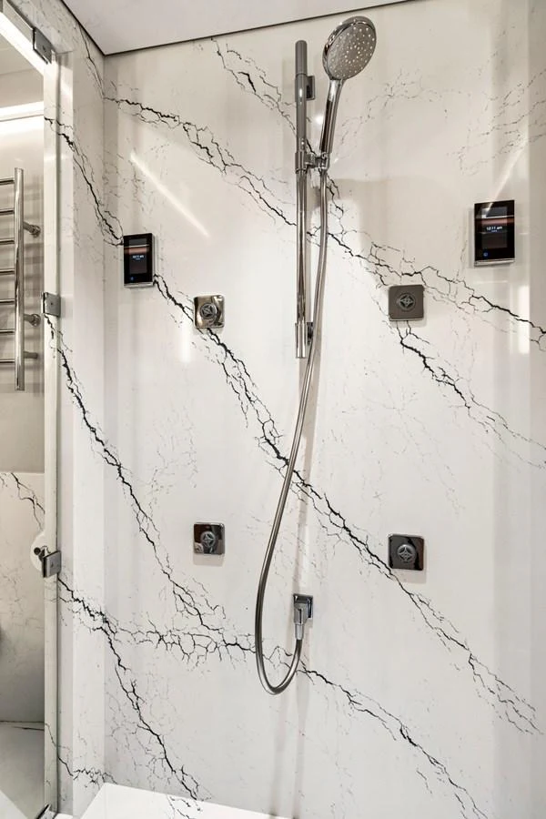 The yacht features a luxurious shower with elegant marble walls and modern fixtures. aboard SEAS THE DAY Yacht for Sale