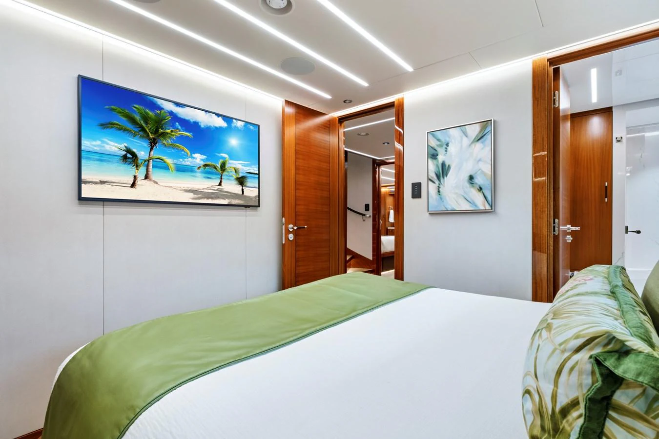 The stateroom features a comfortable bed with modern decor and a large TV. aboard SEAS THE DAY Yacht for Sale