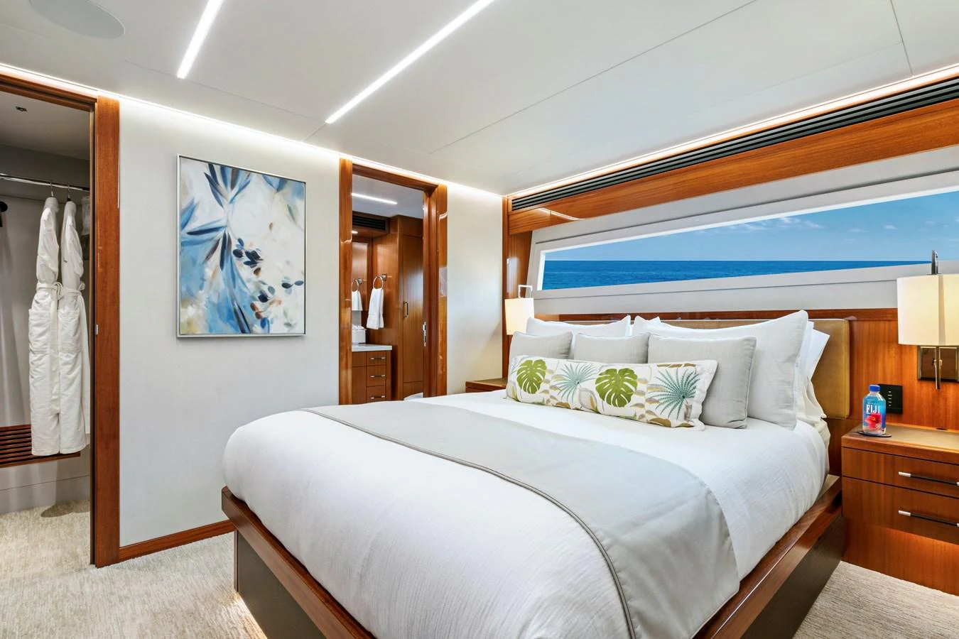 The stateroom features a luxurious bed with elegant decor and ample natural light. aboard SEAS THE DAY Yacht for Sale