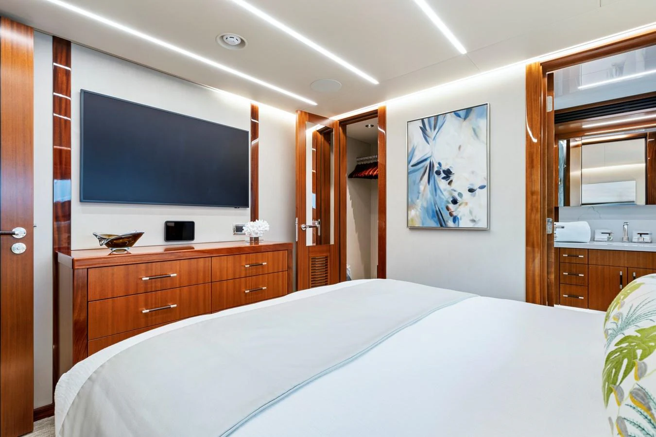 A luxurious stateroom featuring a large bed, modern decor, and ample storage space. aboard SEAS THE DAY Yacht for Sale
