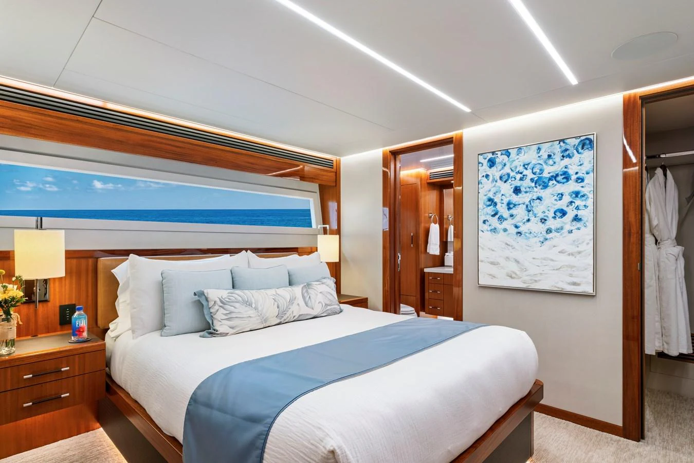 The master stateroom features a luxurious bed with elegant decor and ample natural light. aboard SEAS THE DAY Yacht for Sale