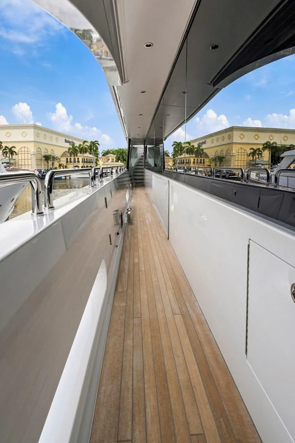 The sleek side deck of the yacht offers a polished walkway with a view of the surroundings. aboard SEAS THE DAY Yacht for Sale