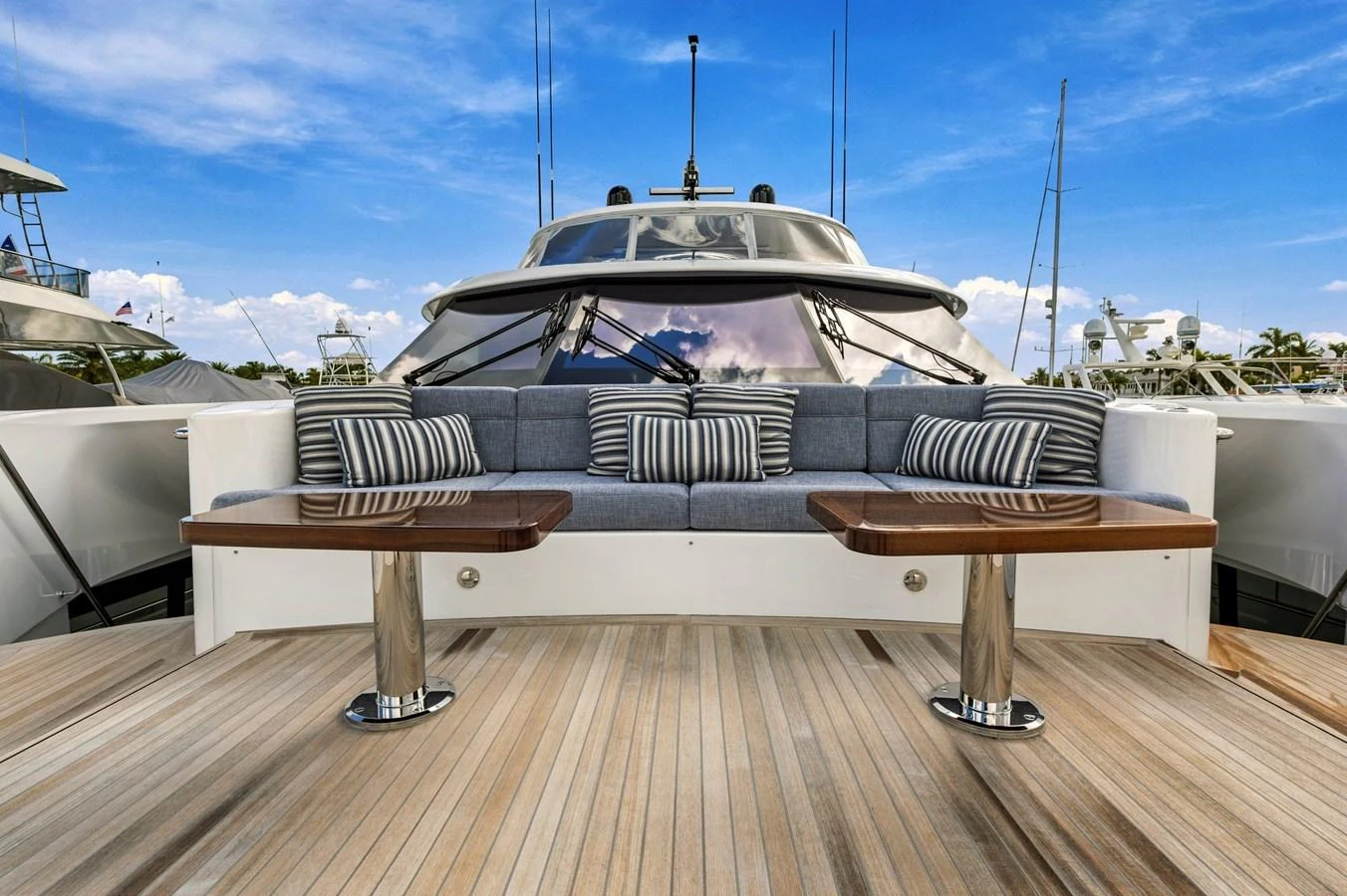 The aft deck features a stylish seating area with plush cushions and polished wooden tables, perfect for relaxation and socializing. aboard SEAS THE DAY Yacht for Sale