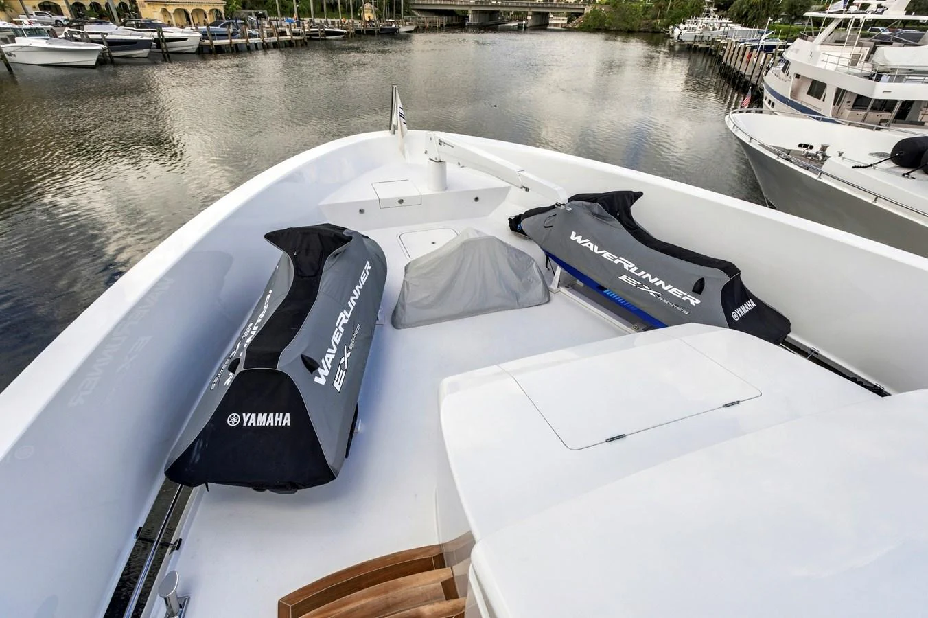 The yacht's deck features two covered Yamaha WaveRunners, ready for thrilling water adventures. aboard SEAS THE DAY Yacht for Sale