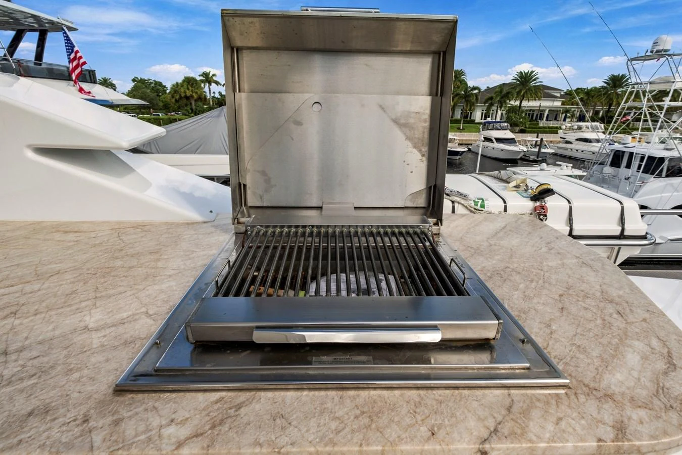 A stainless steel grill is set into a marble countertop, perfect for outdoor cooking on the yacht. aboard SEAS THE DAY Yacht for Sale