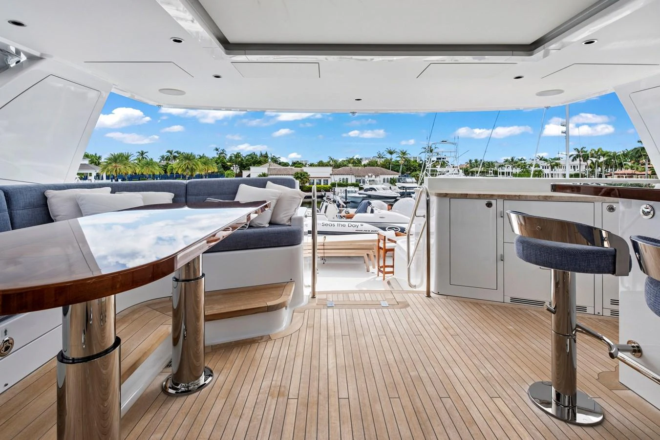 The aft deck offers a spacious and elegant area for relaxation and socializing, featuring comfortable seating and a polished wooden table. aboard SEAS THE DAY Yacht for Sale