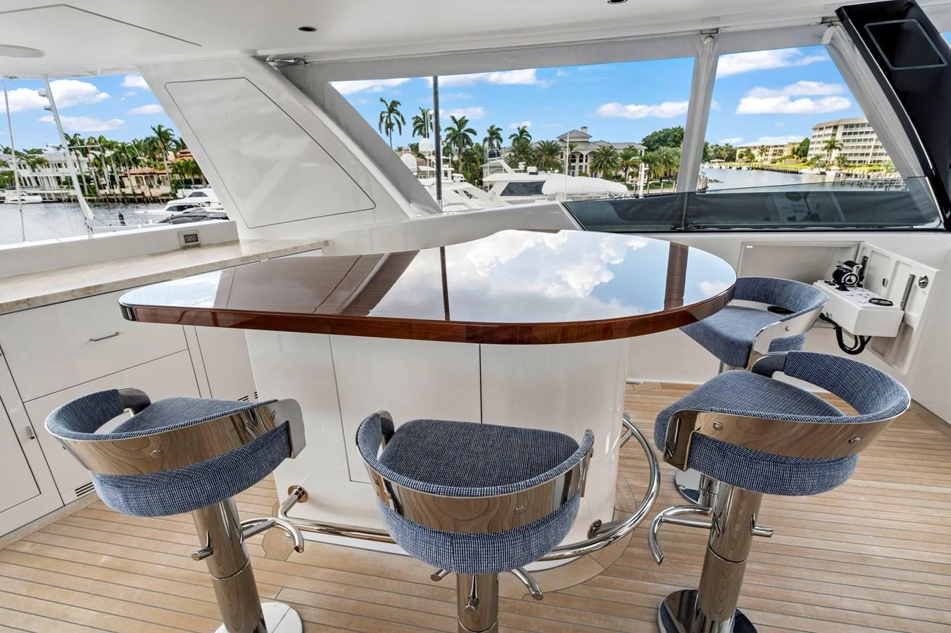 The flybridge features a sleek bar area with modern seating and panoramic views. aboard SEAS THE DAY Yacht for Sale