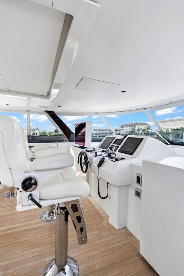 The helm station features modern navigation equipment and comfortable seating with a panoramic view. aboard SEAS THE DAY Yacht for Sale