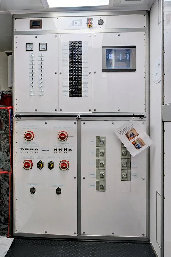 The image showcases a sophisticated control panel with various switches and gauges. aboard SEAS THE DAY Yacht for Sale