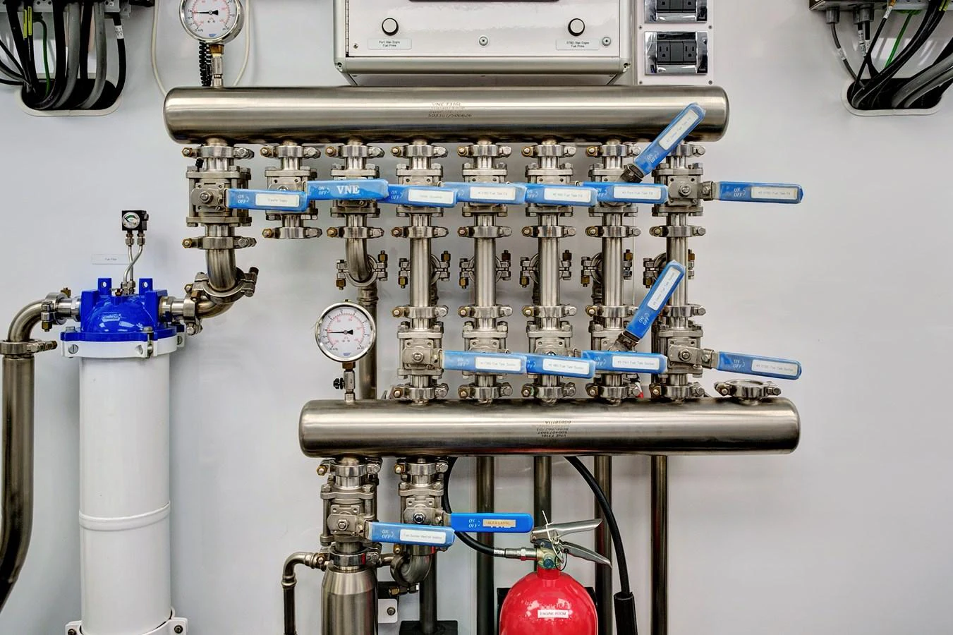 The image showcases the intricate plumbing and control systems within the yacht's engine room. aboard SEAS THE DAY Yacht for Sale