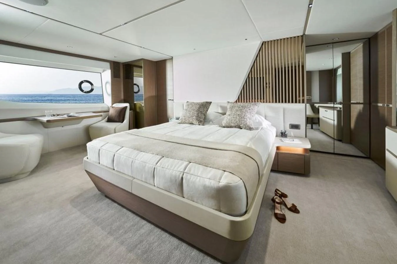 The master stateroom features a spacious bed, modern decor, and a large window with a stunning view. aboard PRINCESS Y88 Yacht for Sale