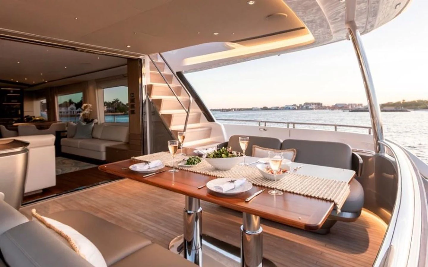 The aft deck features an elegant dining area with a stunning view of the water. aboard PRINCESS Y88 Yacht for Sale