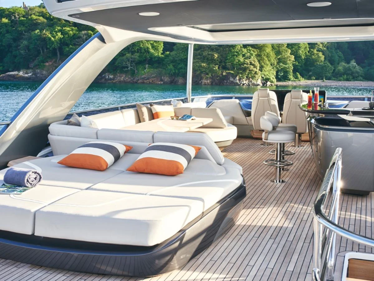 The aft deck features luxurious lounging areas with plush seating and a sleek bar setup, perfect for entertaining. aboard PRINCESS Y88 Yacht for Sale