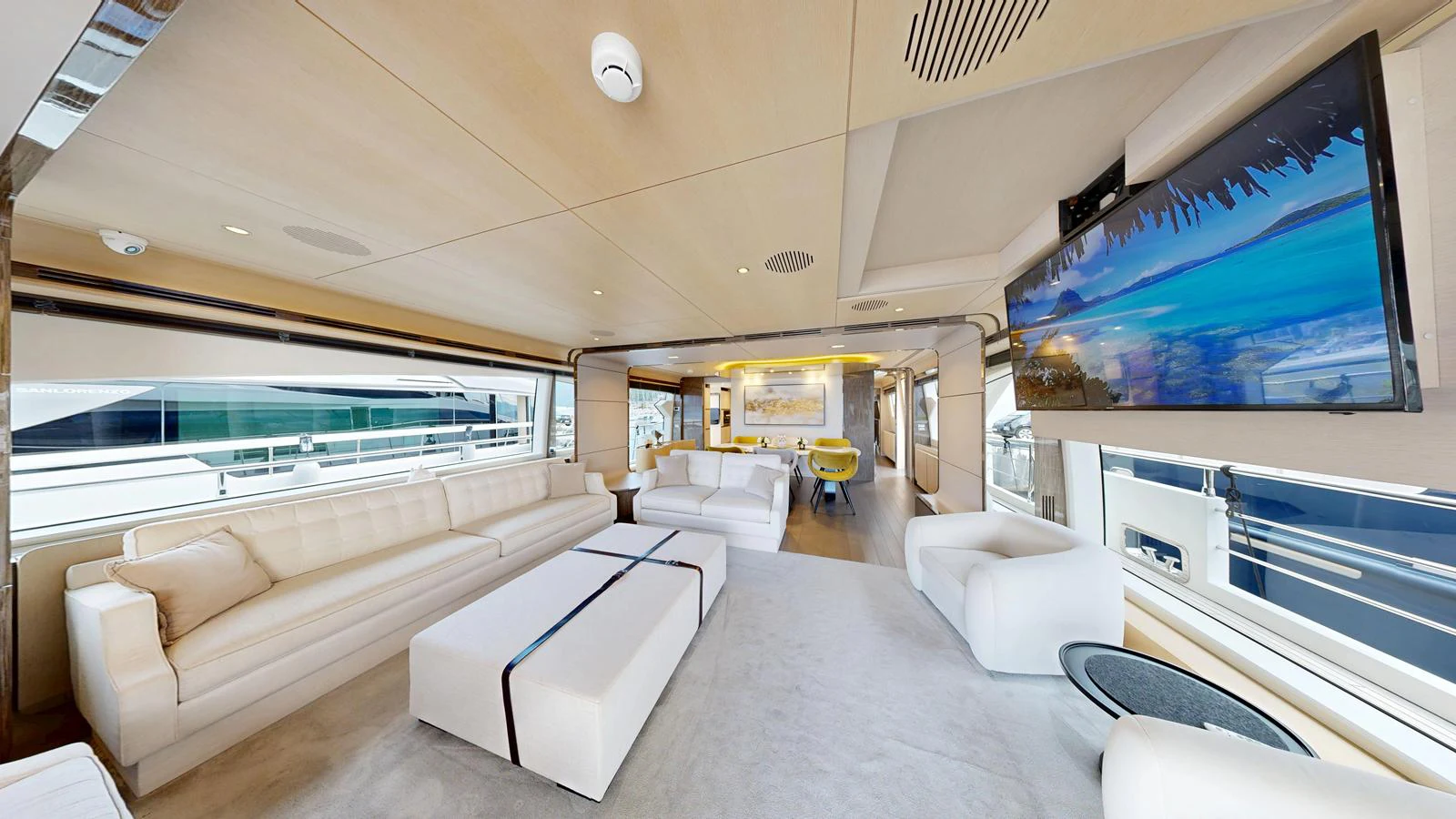 The spacious salon features luxurious seating and a large flat-screen TV, creating an inviting atmosphere for relaxation and entertainment. aboard 98.92' AZIMUT GRANDE Yacht for Sale