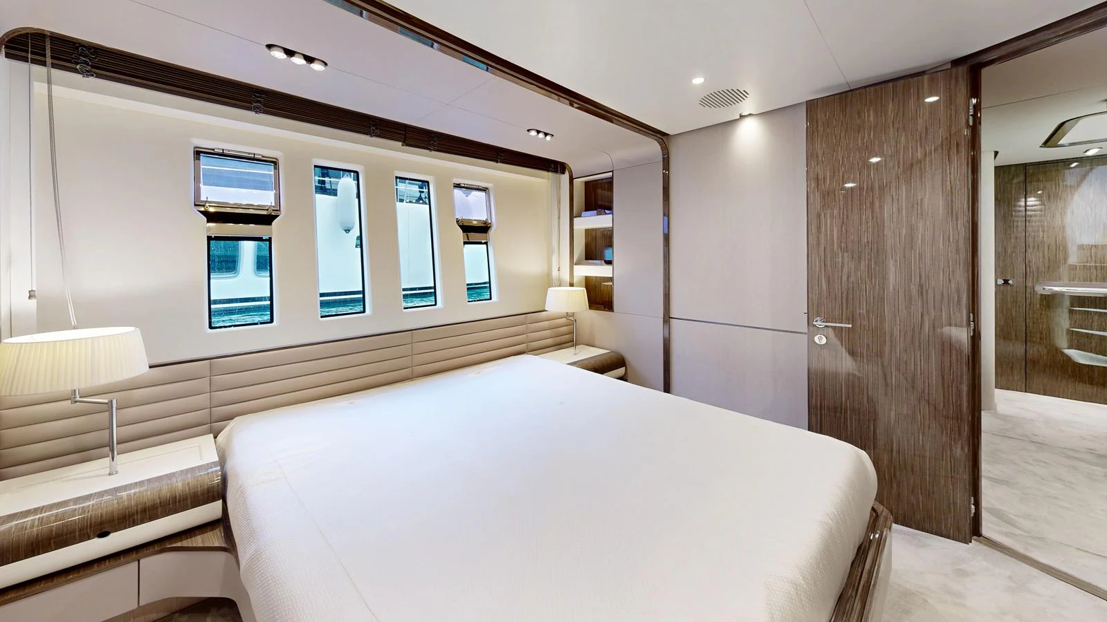 The master stateroom features a spacious bed, modern lighting, and elegant wood finishes. aboard 98.92' AZIMUT GRANDE Yacht for Sale
