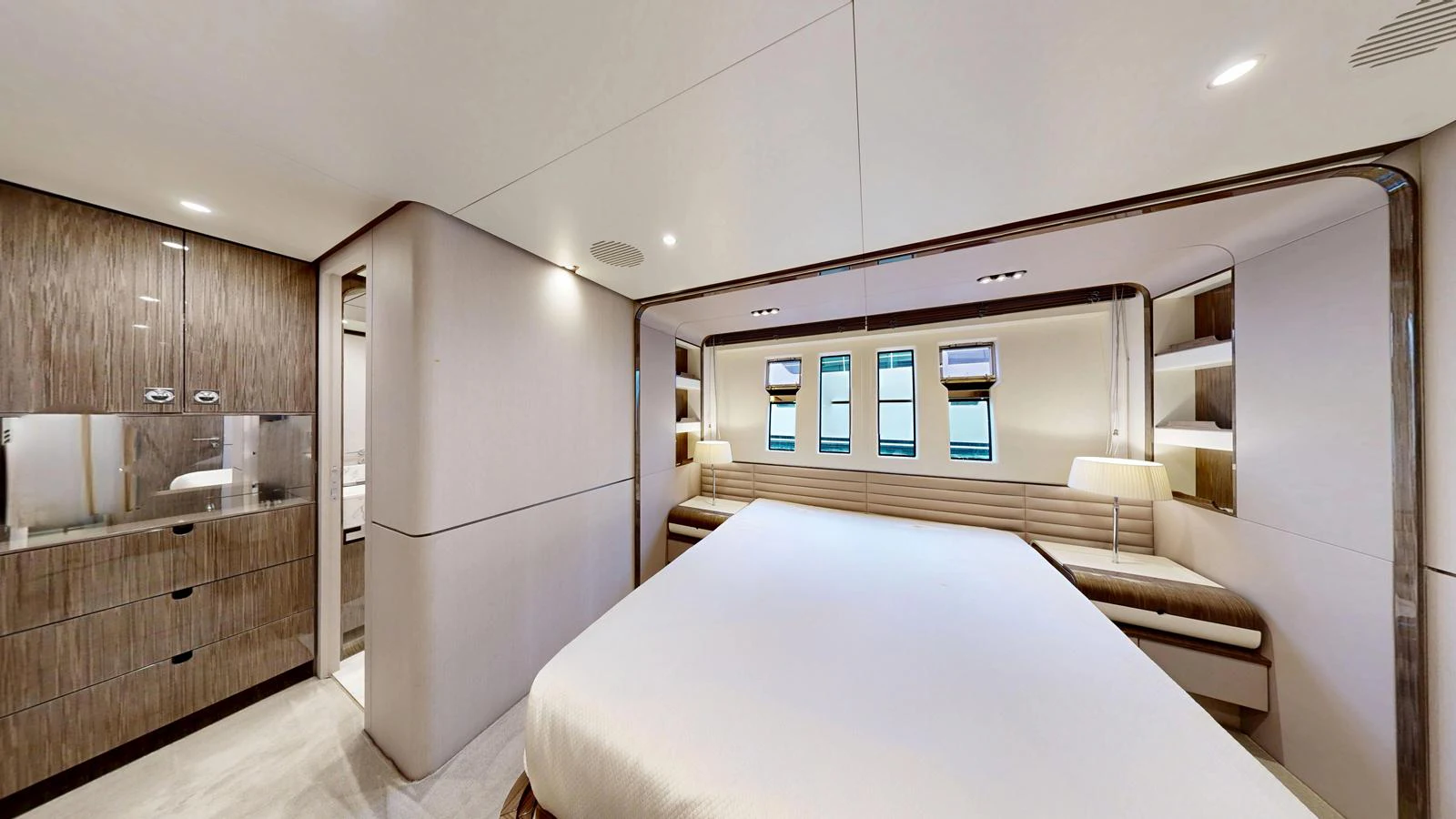 The master stateroom features a spacious bed, modern cabinetry, and ample natural light. aboard 98.92' AZIMUT GRANDE Yacht for Sale