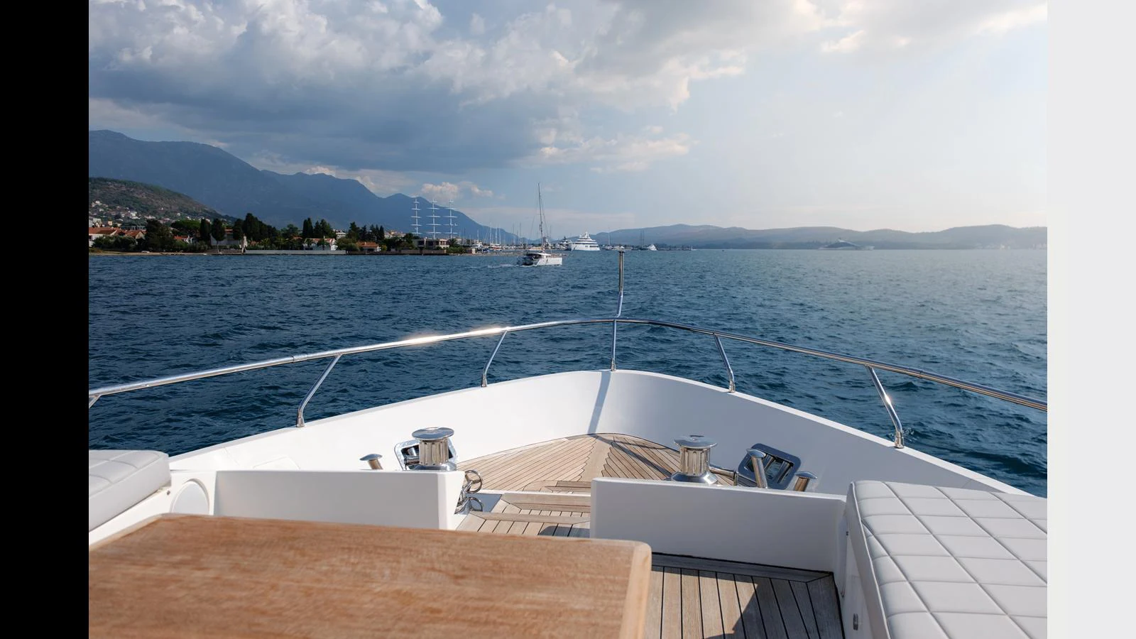 The bow of the yacht offers a serene view of the open water and distant coastline. aboard 98.92' AZIMUT GRANDE Yacht for Sale