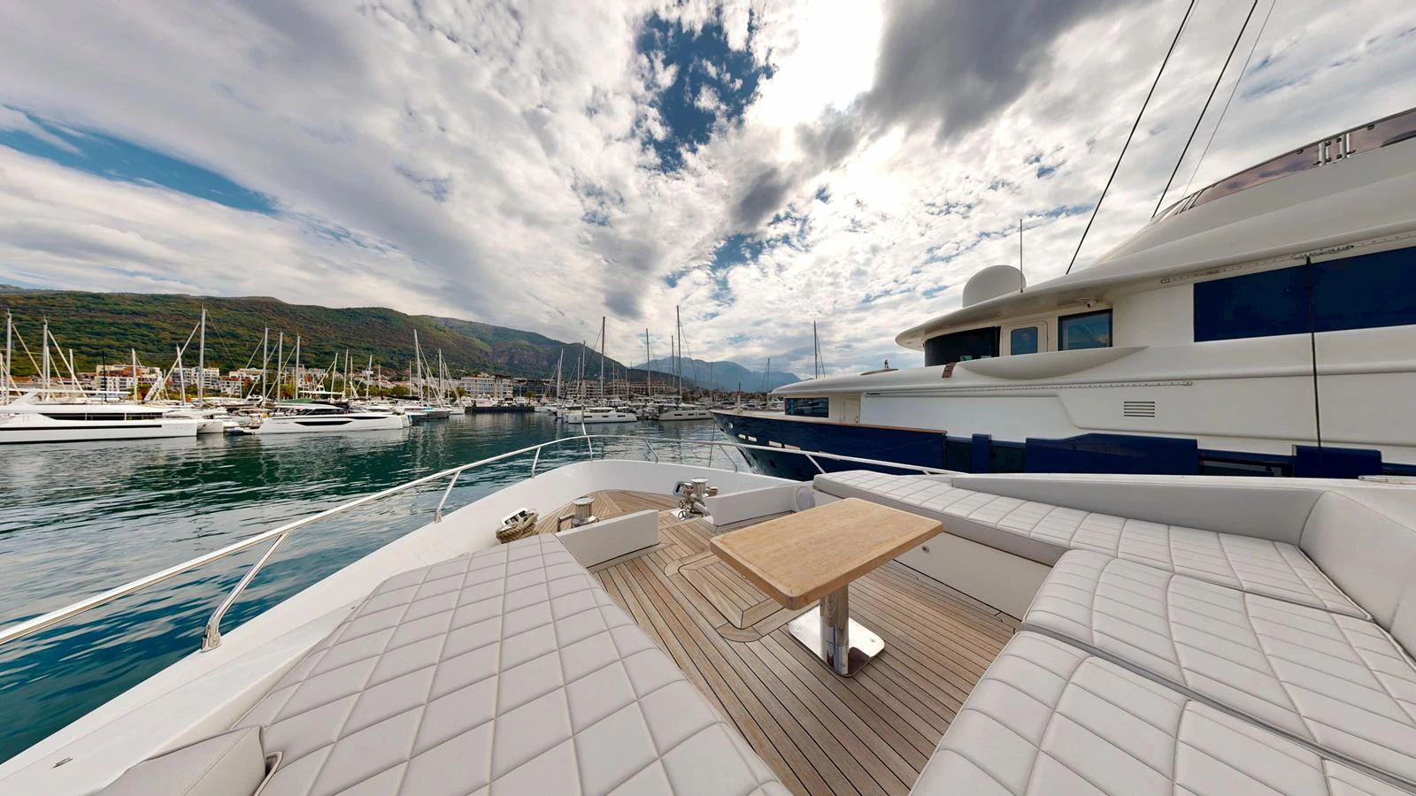 The foredeck offers a spacious and inviting area with plush seating and a central table, perfect for relaxation and socializing. aboard 98.92' AZIMUT GRANDE Yacht for Sale