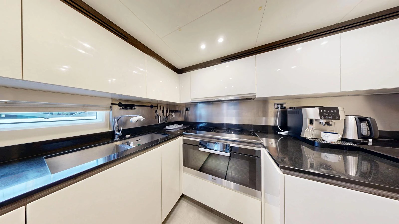 The yacht's galley is equipped with modern appliances and sleek cabinetry, offering a stylish and functional space for meal preparation. aboard 98.92' AZIMUT GRANDE Yacht for Sale