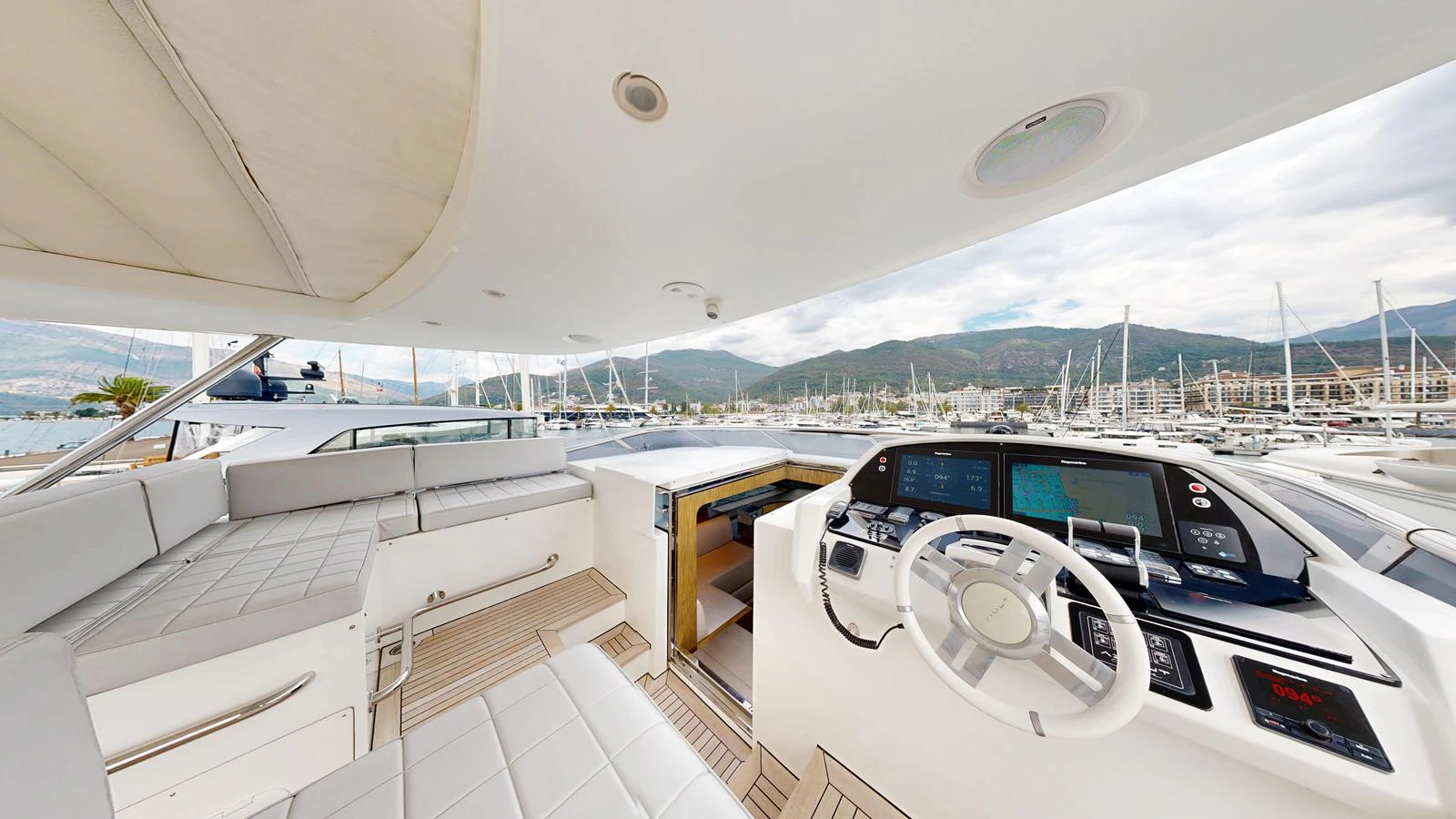 The yacht's helm station offers a modern and spacious area for navigation with a panoramic view of the marina. aboard 98.92' AZIMUT GRANDE Yacht for Sale