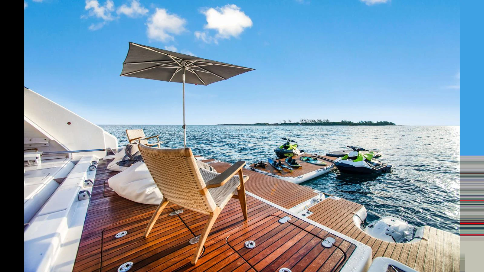 The yacht's swim platform features comfortable seating and easy access to water toys, perfect for enjoying the ocean. aboard MIDORI Yacht for Sale