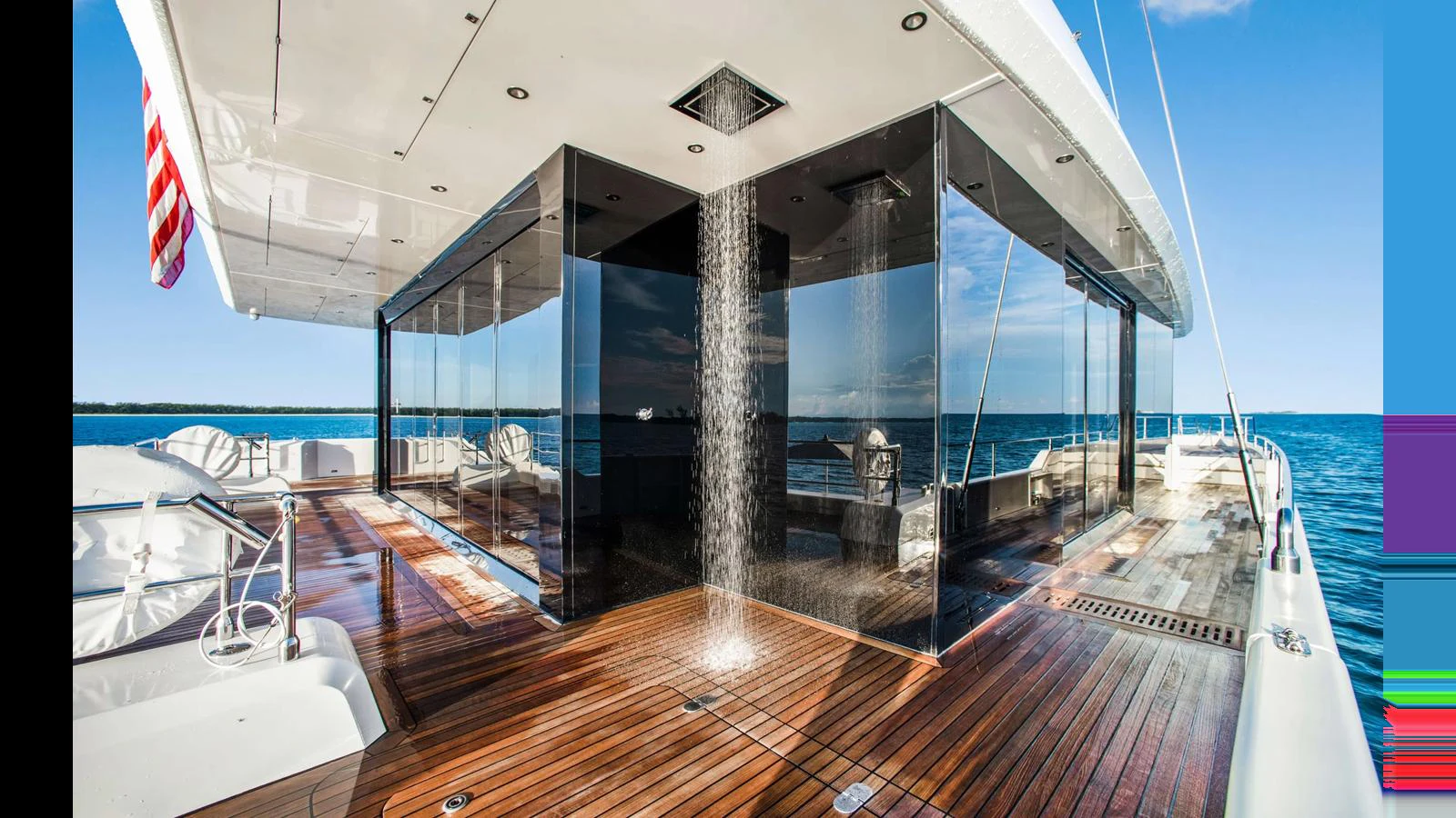 The yacht's aft deck features a luxurious outdoor shower with stunning ocean views. aboard MIDORI Yacht for Sale