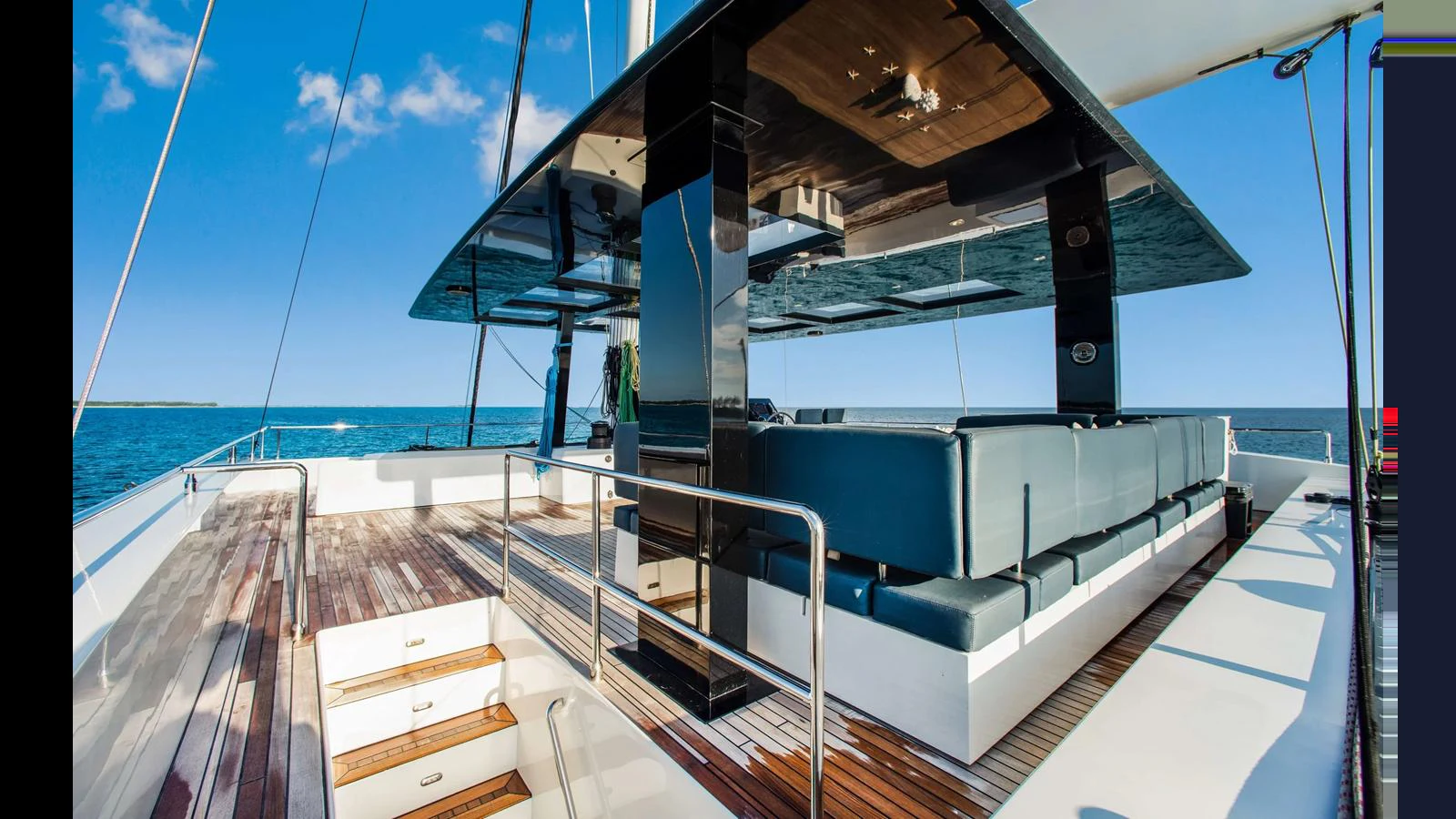 The aft deck features a spacious seating area with sleek, modern design elements and stunning ocean views. aboard MIDORI Yacht for Sale