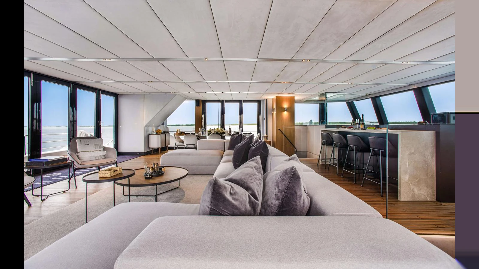 The spacious salon features modern furnishings and expansive windows offering stunning views. aboard MIDORI Yacht for Sale